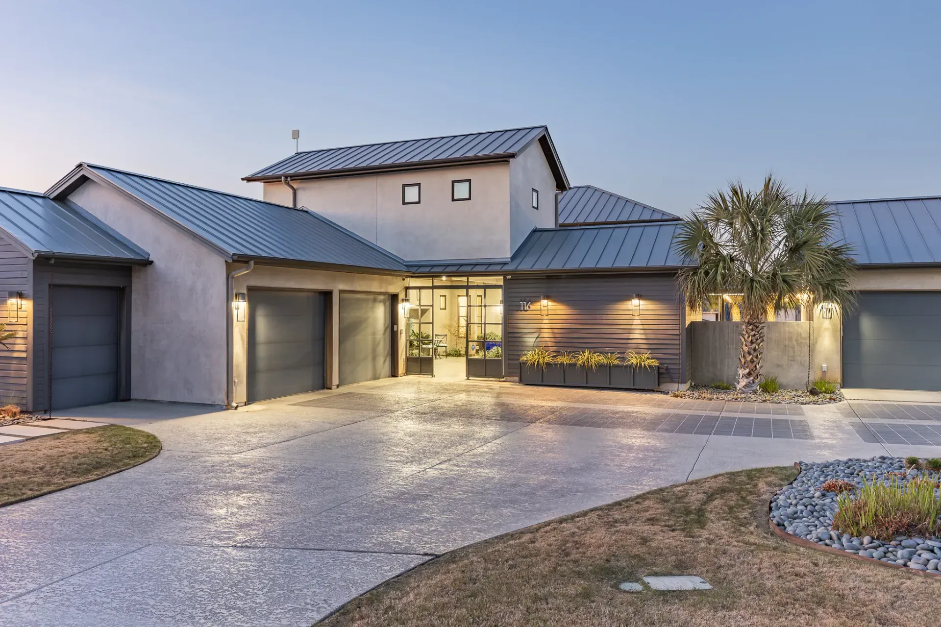 Front exterior at twilight with landscape lighting